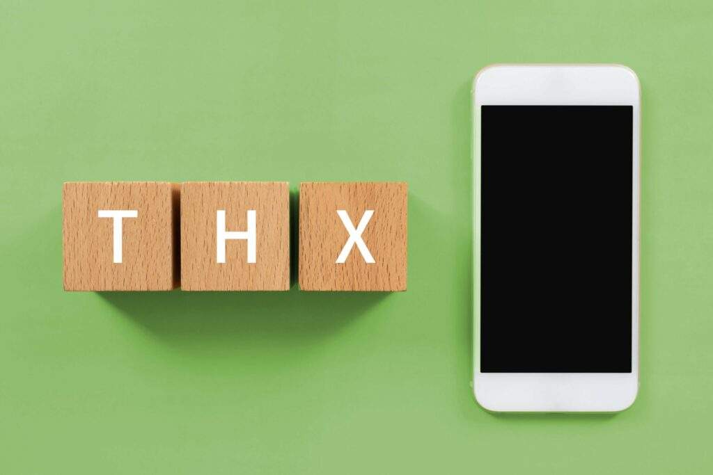 wooden blocks with thx text of concept and smartphone 1 scaled